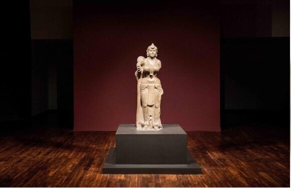 The Didarganj Yakshi sculpture displayed in a softly lit gallery
