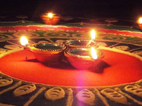Colourful rangoli decorated with glowing diyas in Goa, western India