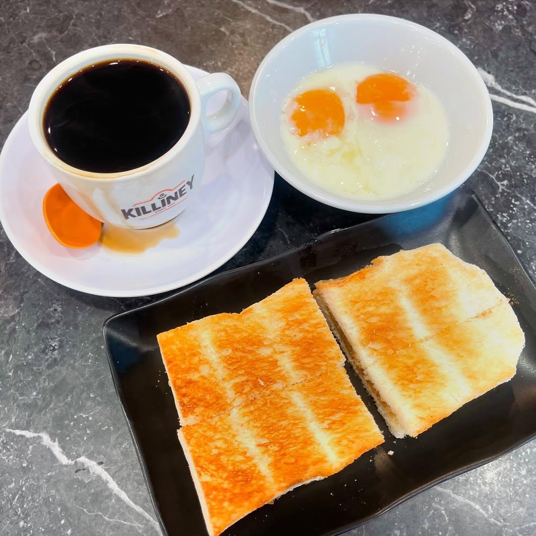 Singapore kaya toast breakfast with soft-boiled eggs and kopi