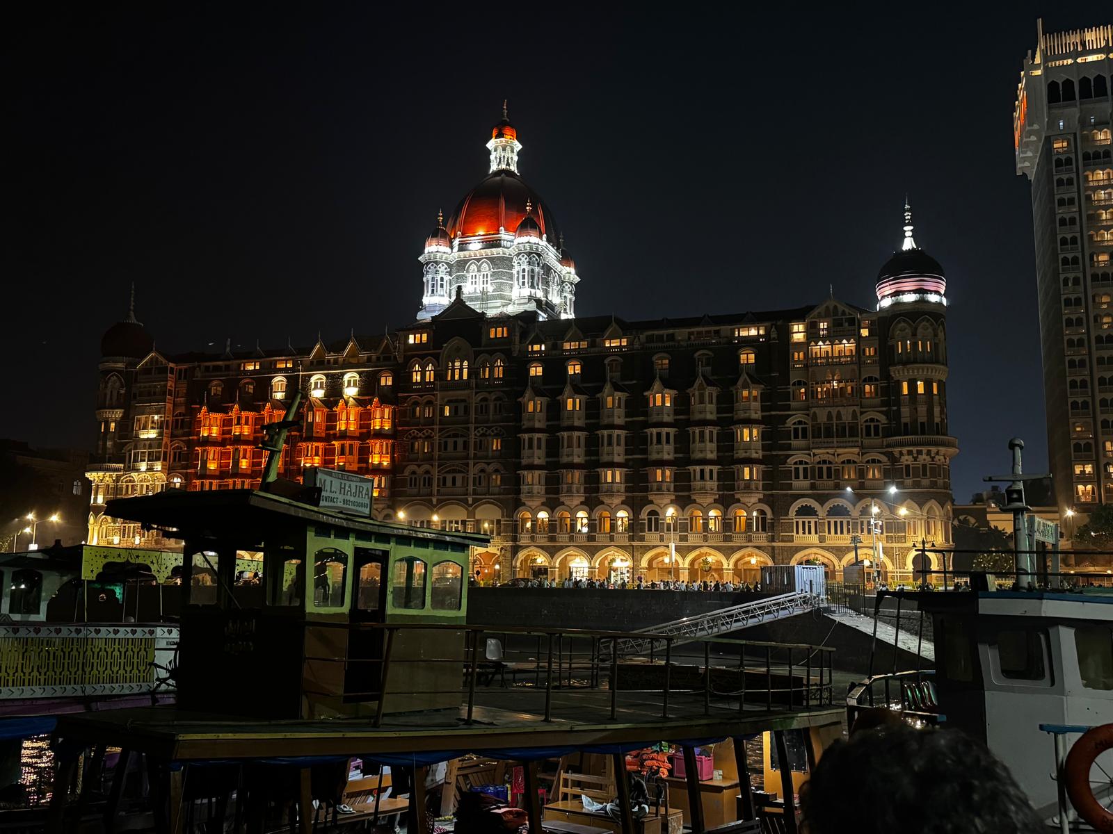 The illuminated Taj Mahal Palace Hotel beside Mumbai’s waterfront at night