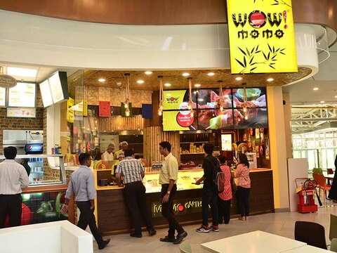 Customers at a WOW! Momo restaurant counter